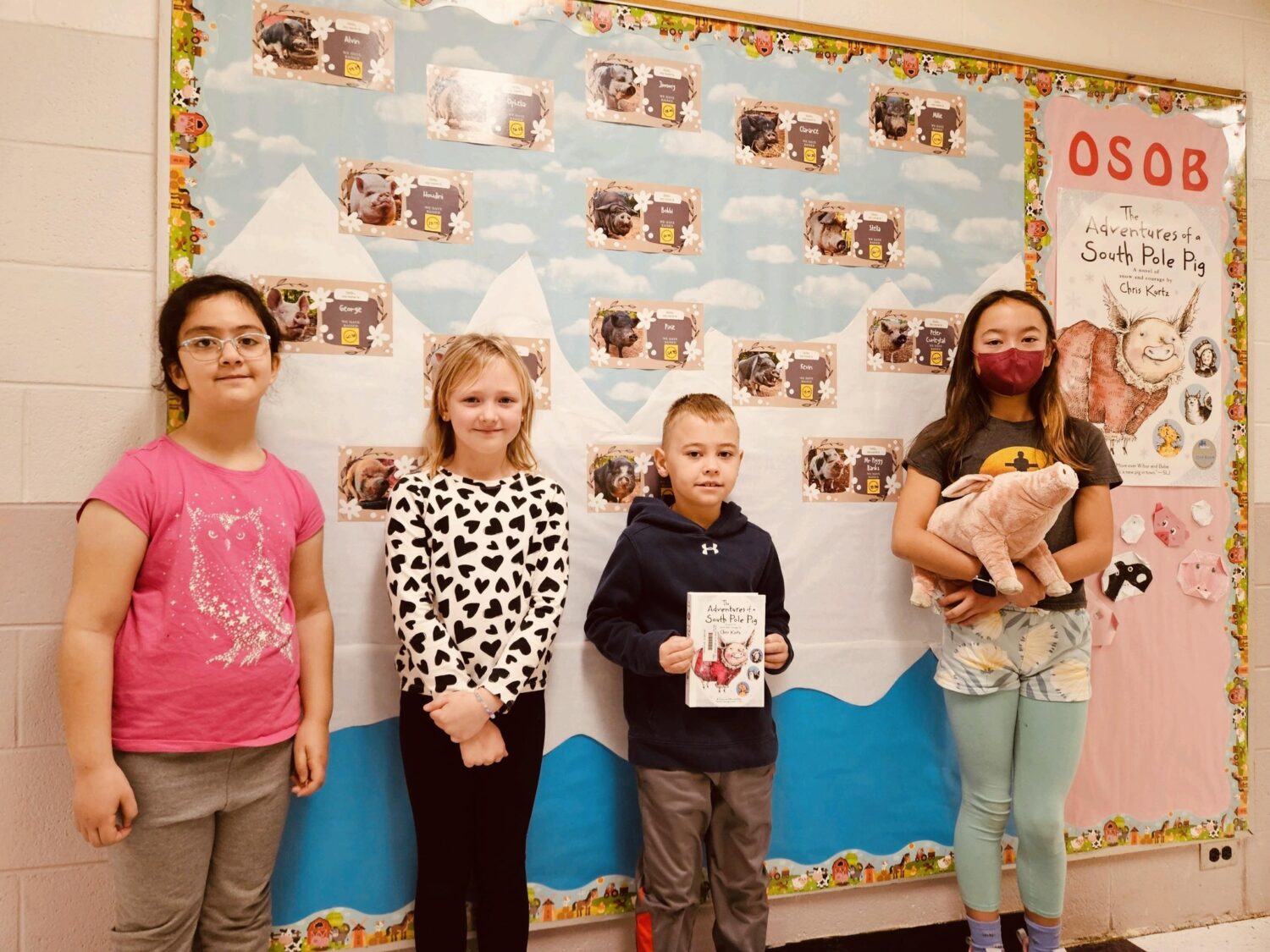 HAES students in front of pig fundraising chart