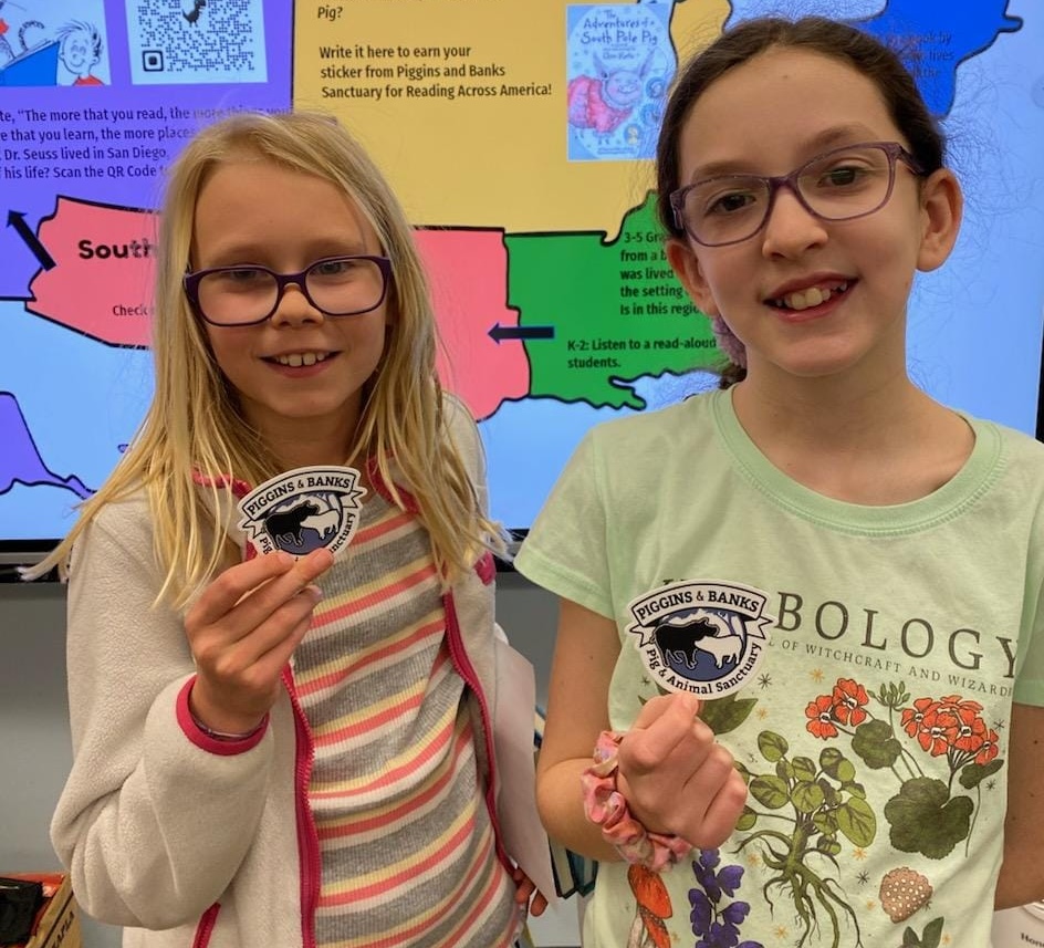 HAES students showing off piggins and banks stickers